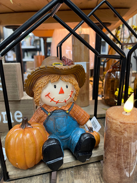 Sitting Scarecrow with Pumpkins